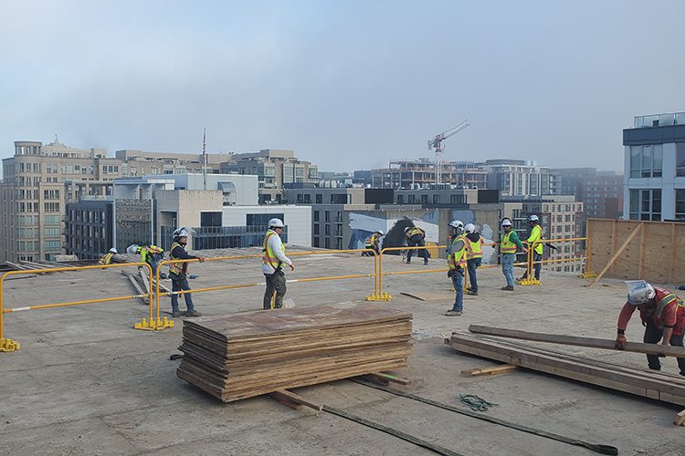 Demolition crew on the roof maintaining a clean worksite