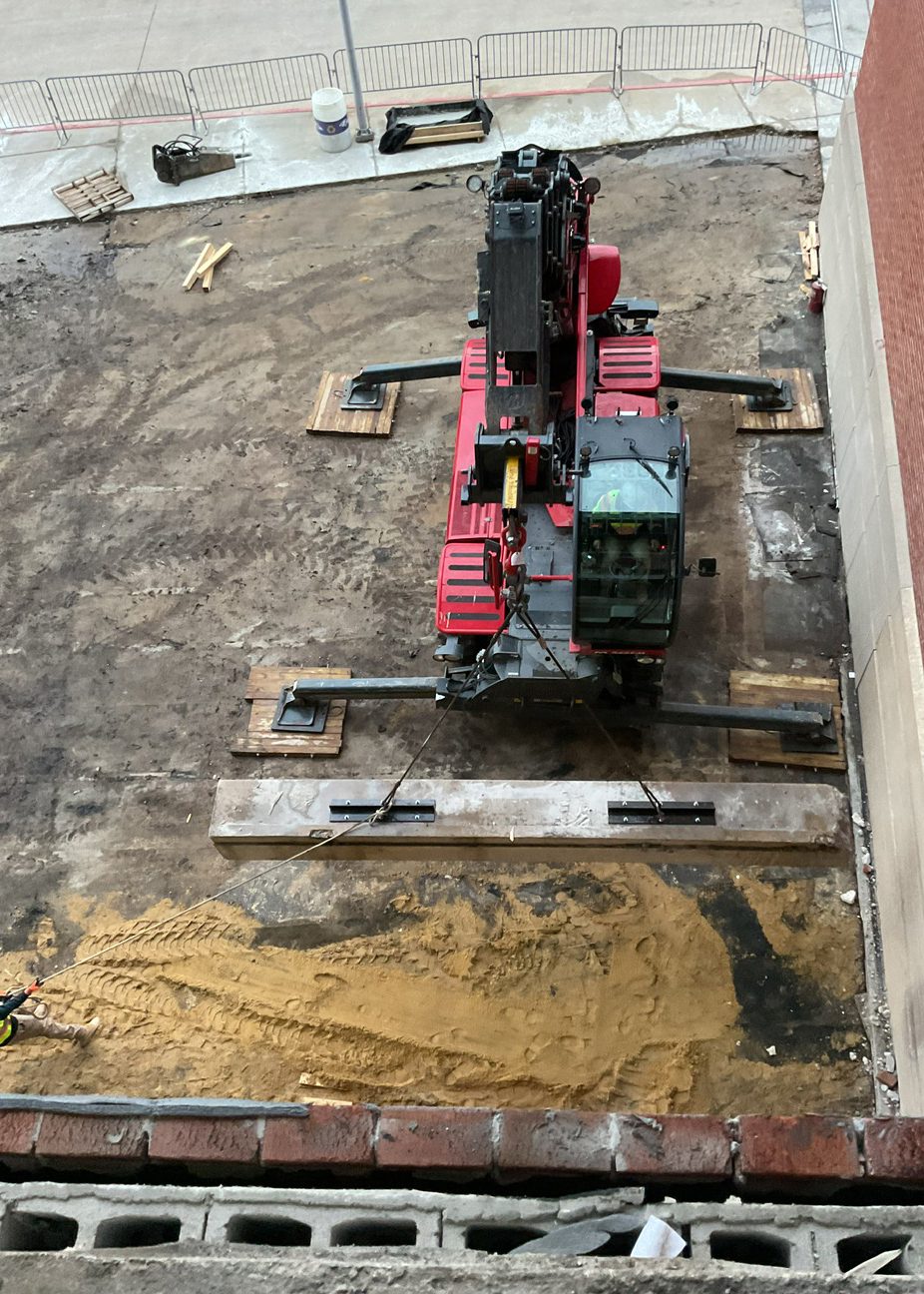 Crane lowering beams during demolition