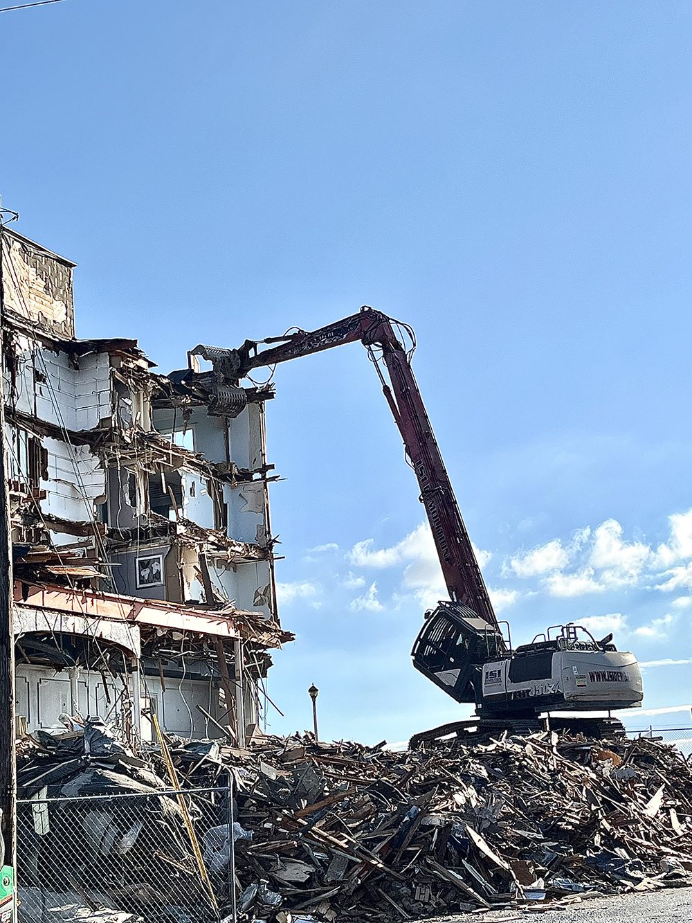 High Reach Excavators work on the demolition of the hotel in Ocean City, Maryland