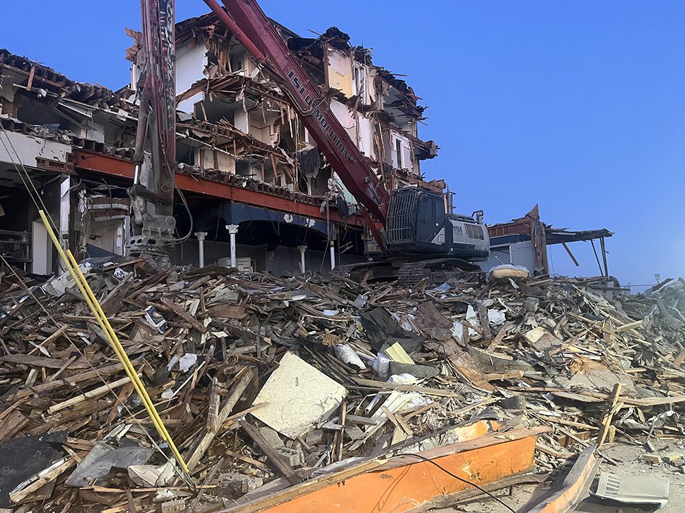 An excavator sorting through debris at the Beach Plaza Hotel Demolition in Ocean City, Maryland