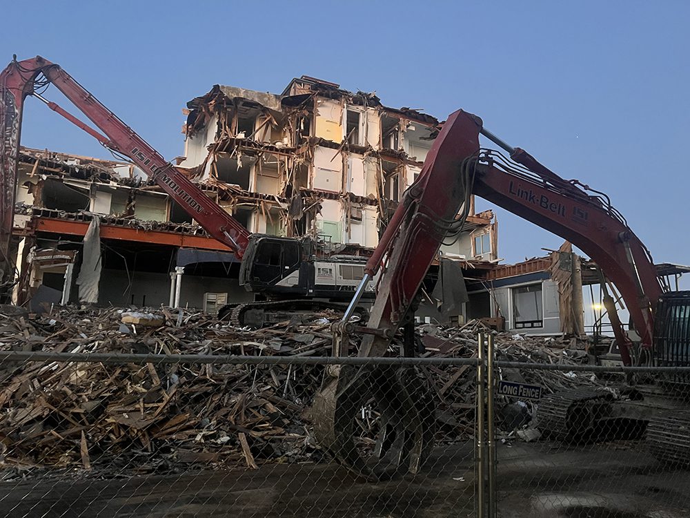 Multiple excavators work on the demolition of the hotel along the Ocean City Boardwalk