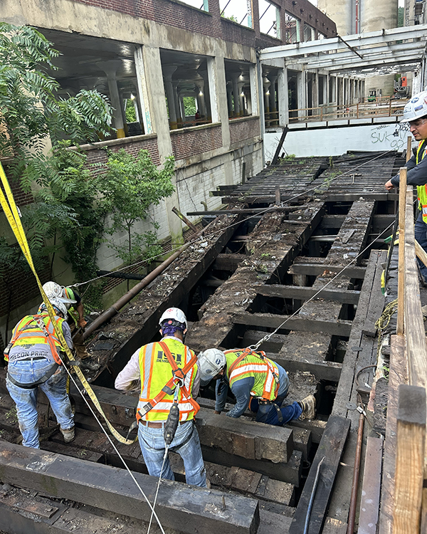 Removing beams Crews working on large beam removal during demolition