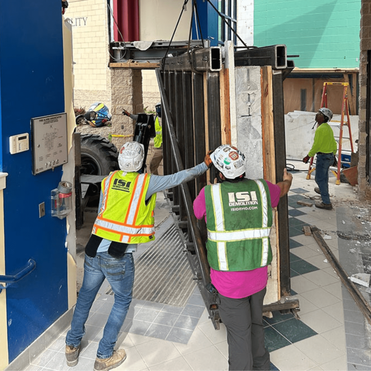 Crews rigging equipment during interior demolition