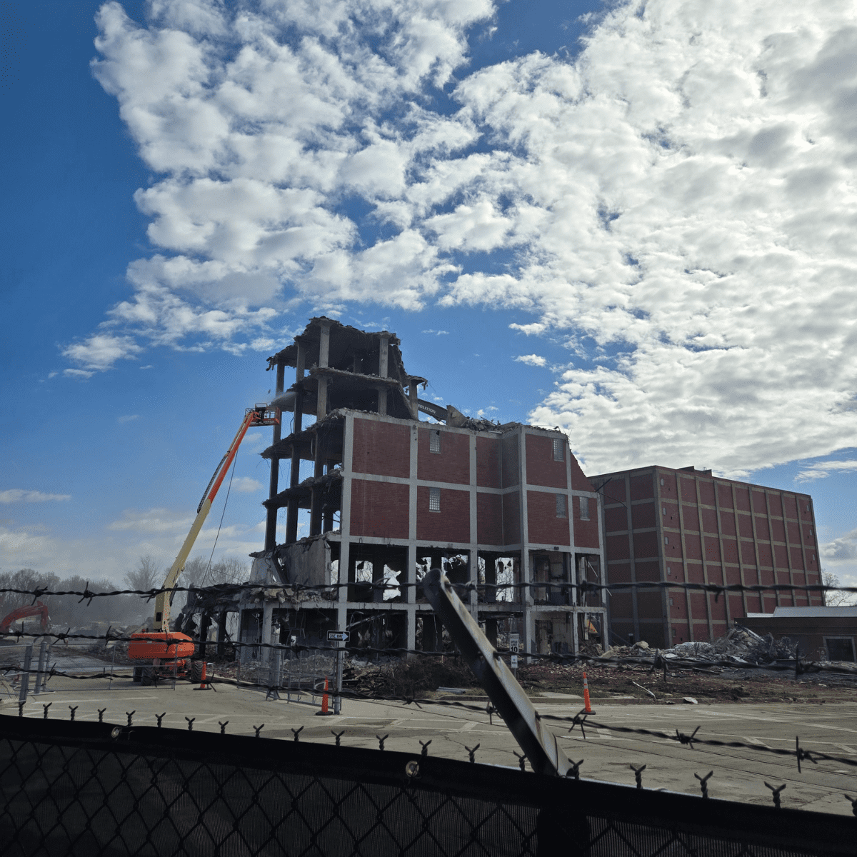 Crews rigging equipment during interior demolition