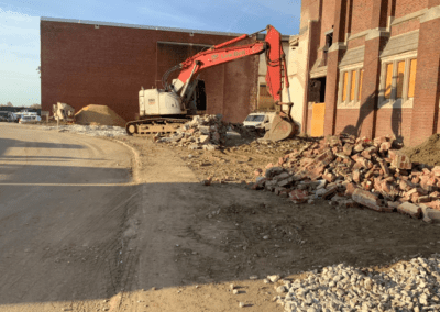Excavator outside a Baltimore City public school during demolition