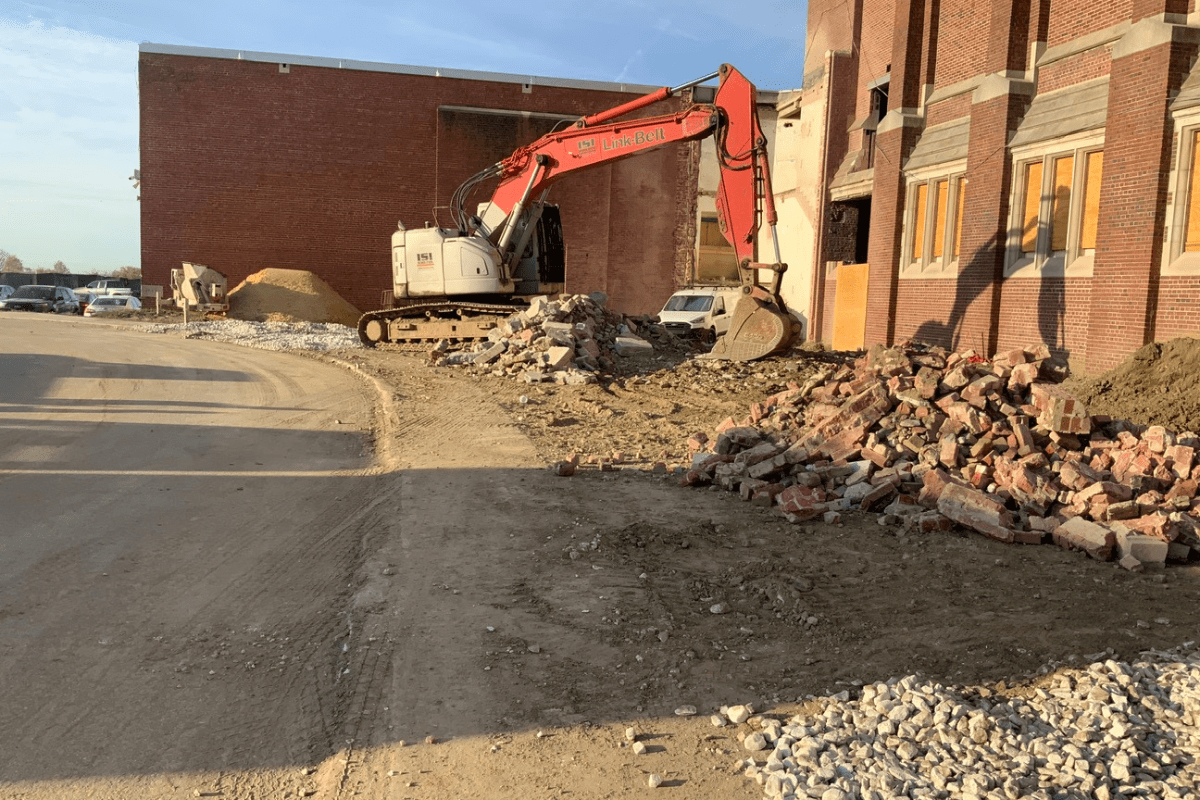 Excavator outside a Baltimore City public school during demolition