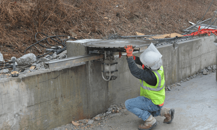 Demolition worker setting the saw blade