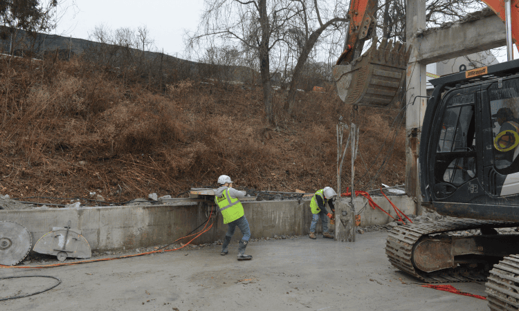 Demolition crew setting up for saw cutting to get a clean edge on the former cement pillar