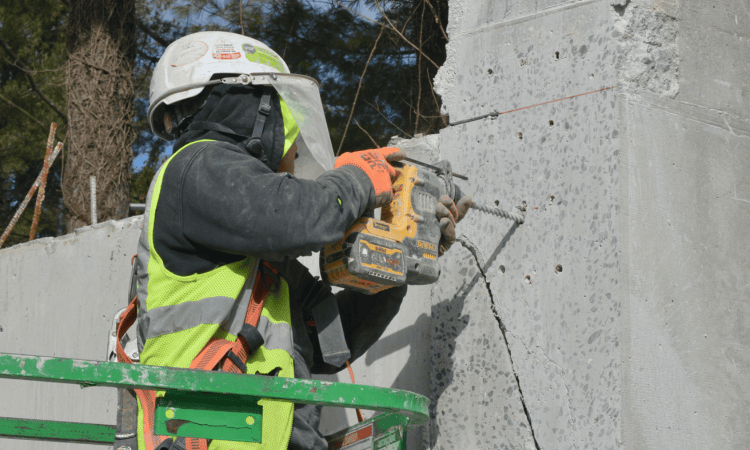 demolition worker using a drill to prepare for the track saw