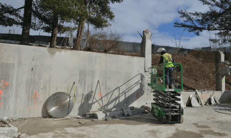 worker on a scissor lift preparing for a track saw