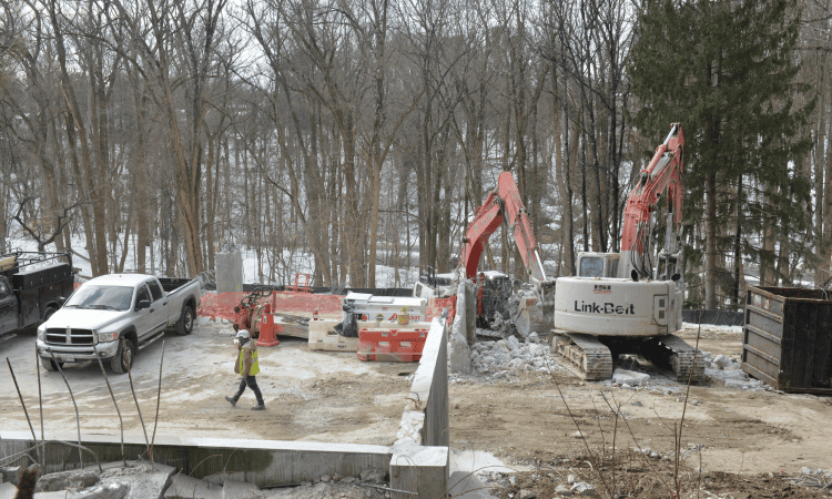 multiple excavators working together to remove debris