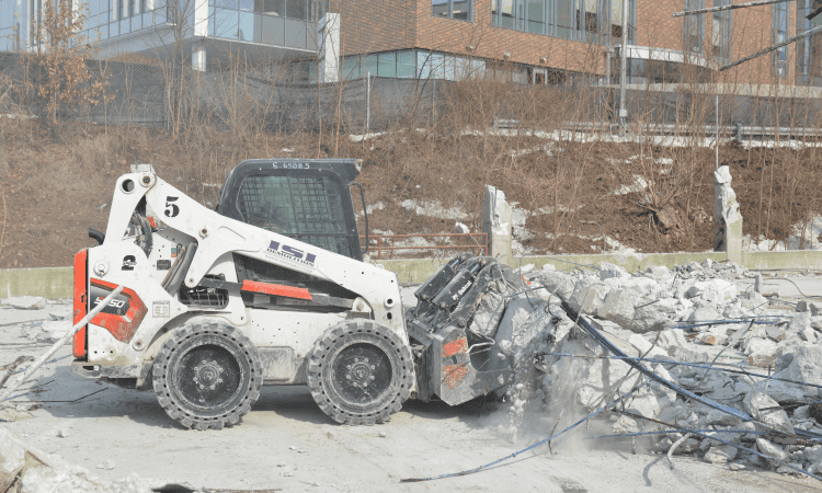 Bobcat removing metal from the jobsite