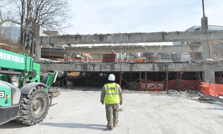 demolition worker walking towards the garage