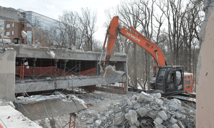 excavators removing concrete from the parking garage
