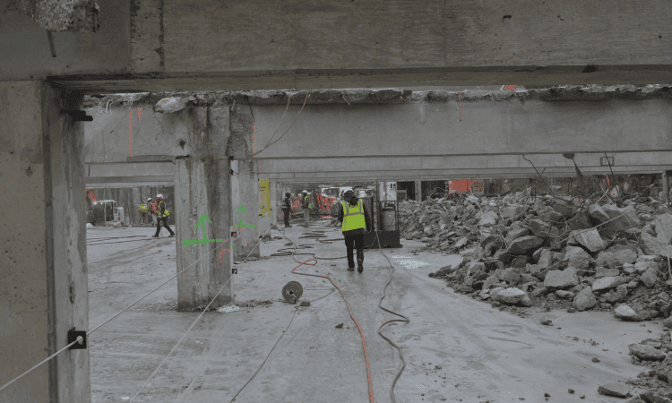 demolition crews working to dismantle the parking garage